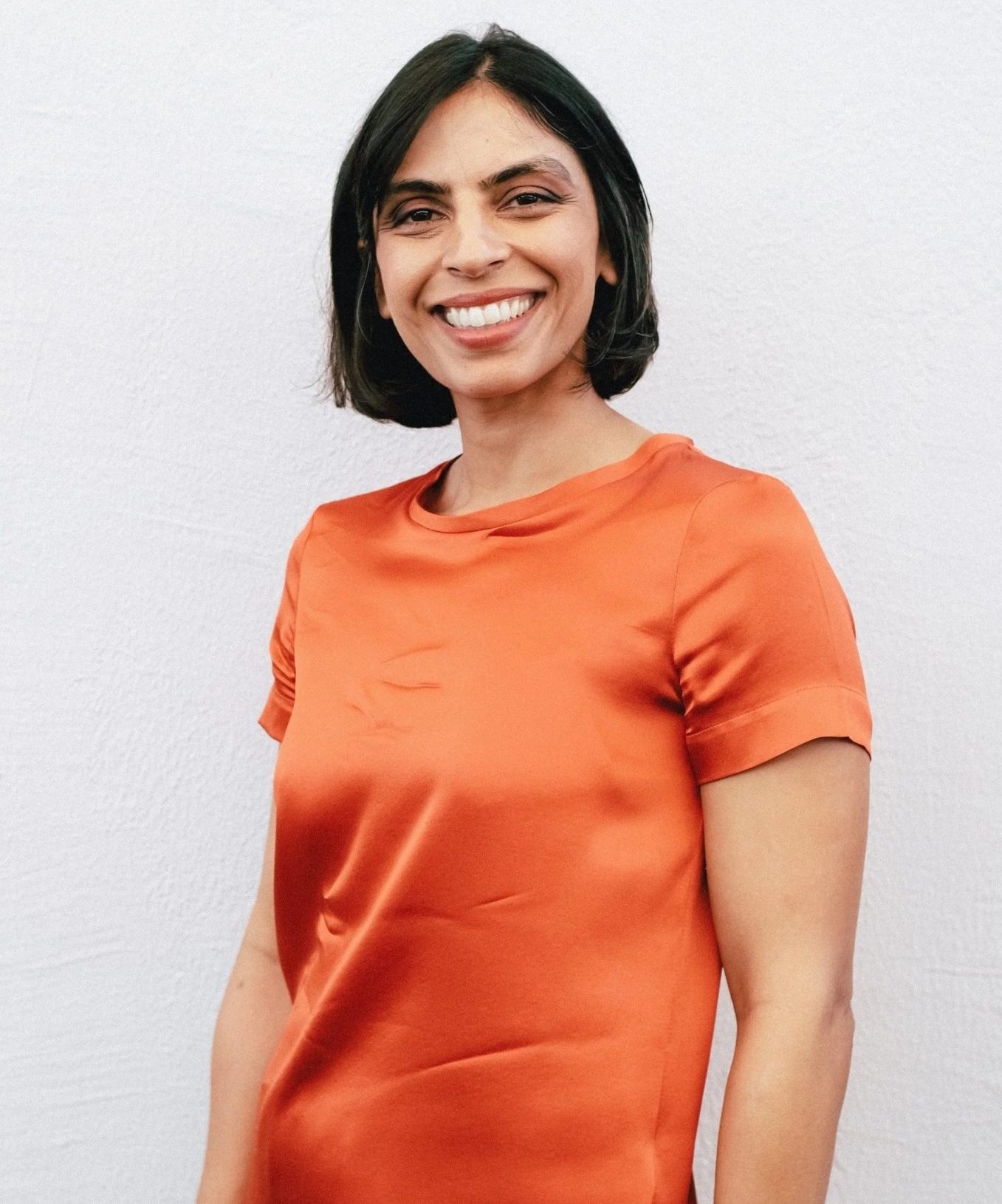 Smiling woman in an orange shirt